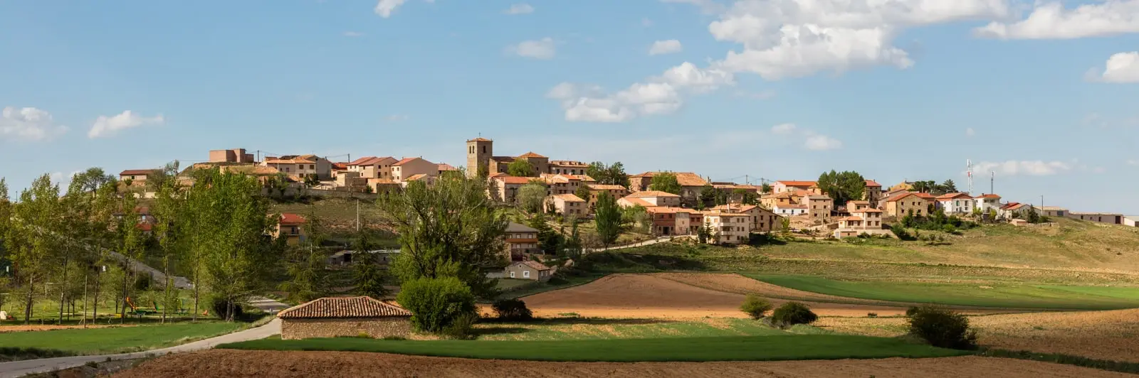 Panoramic view of Adobes, Guadalajara, with houses and the church in the village centre.