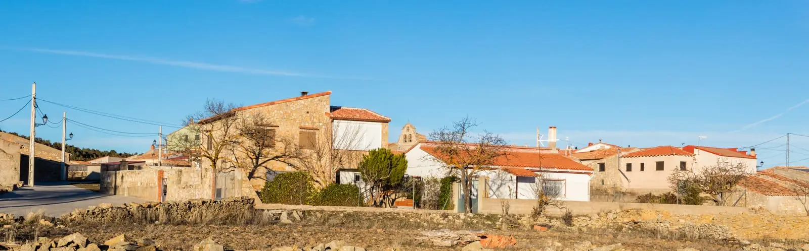 Panoramic view of Amayas’s stone houses and the church bell-gable in the village centre.