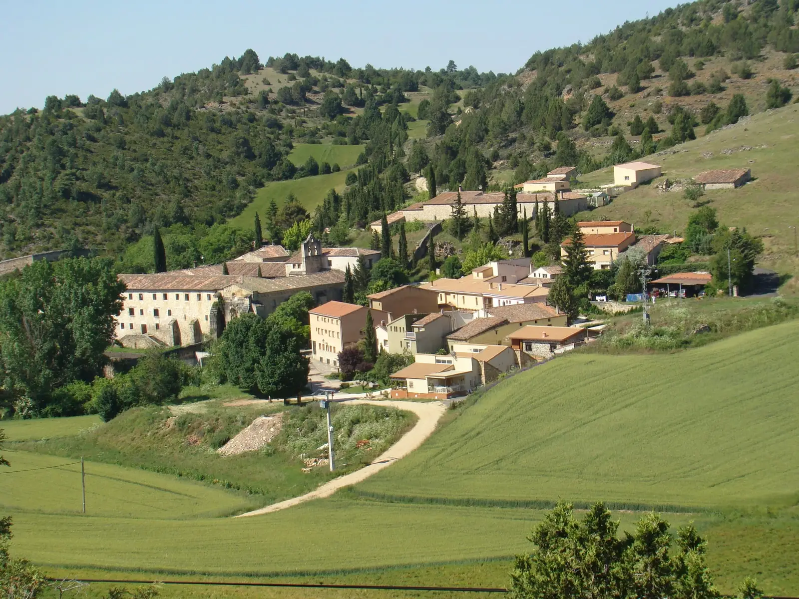 Buenafuente del Sistal and its Cistercian monastery among fields and hillsides.