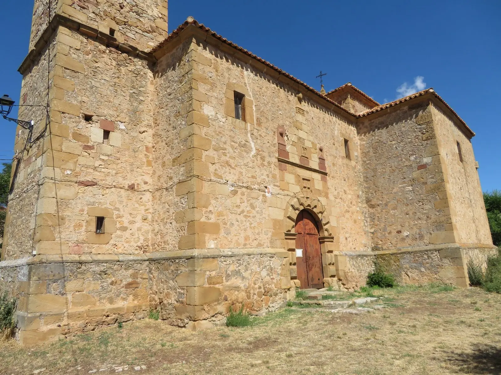 Stone façade of San Julián parish church in Morenilla.
