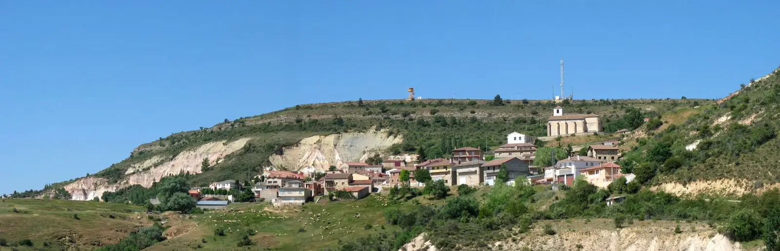Panoramic view of Peñalén, Guadalajara, from the north-east below a limestone hillside.