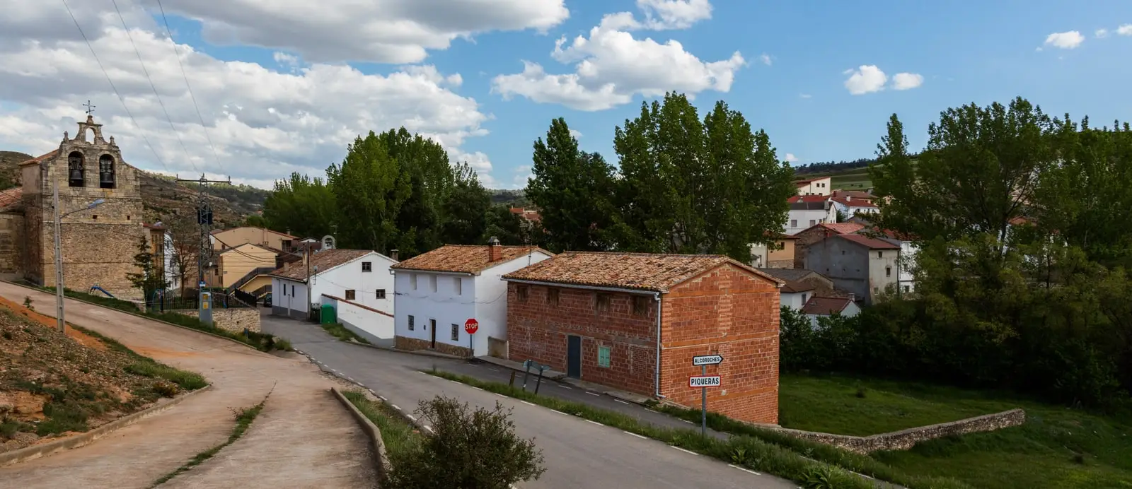 Piqueras, Guadalajara, with its bell tower and the “Piqueras” entrance sign.