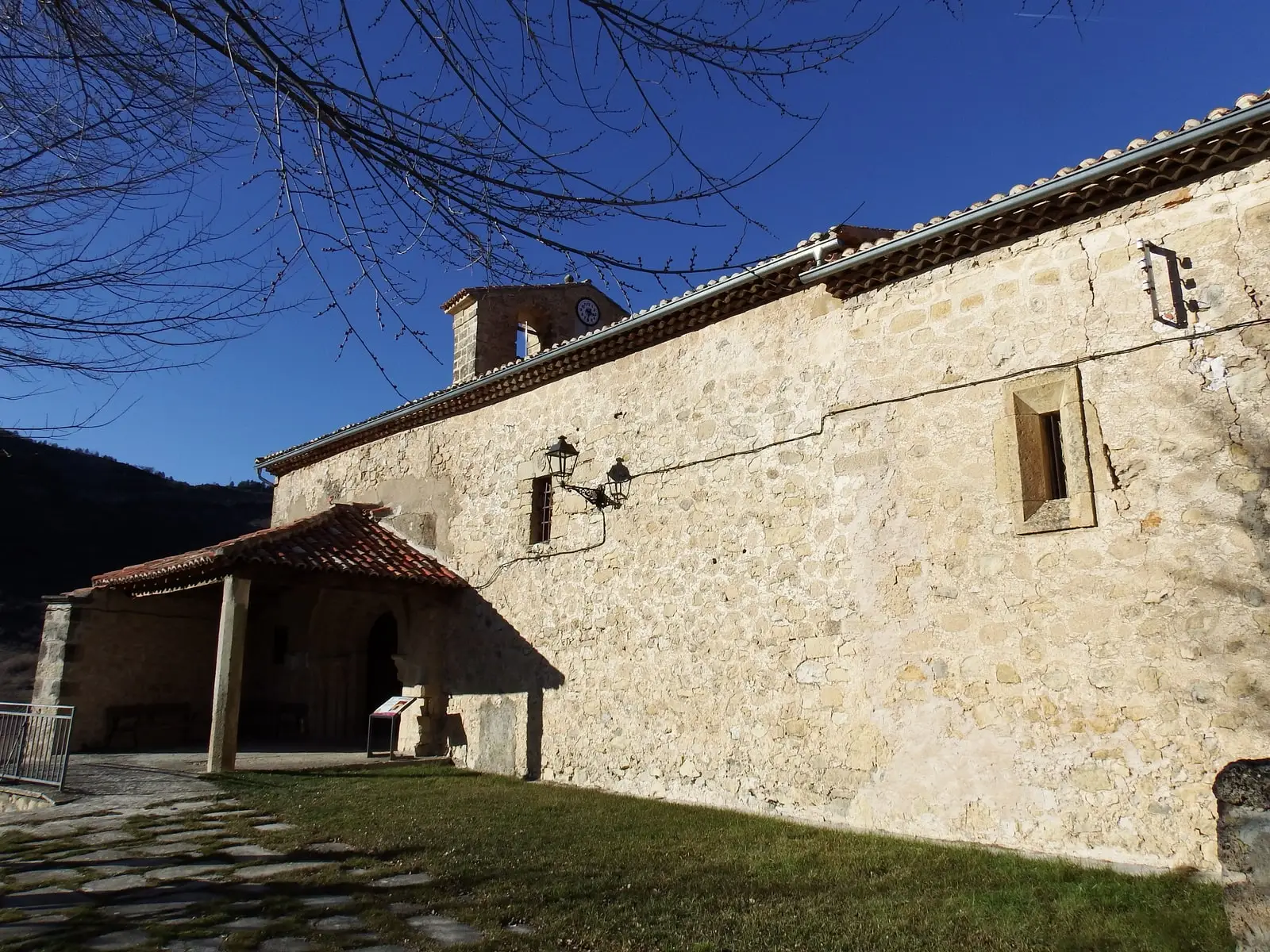 Stone façade of Nuestra Señora de los Remedios church in Poveda de la Sierra.