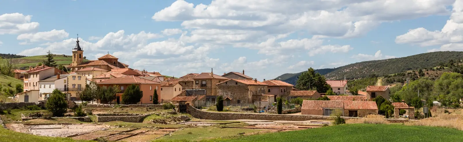 Panoramic view of Terzaga with houses and the church beside the historical saltworks’ evaporation beds.