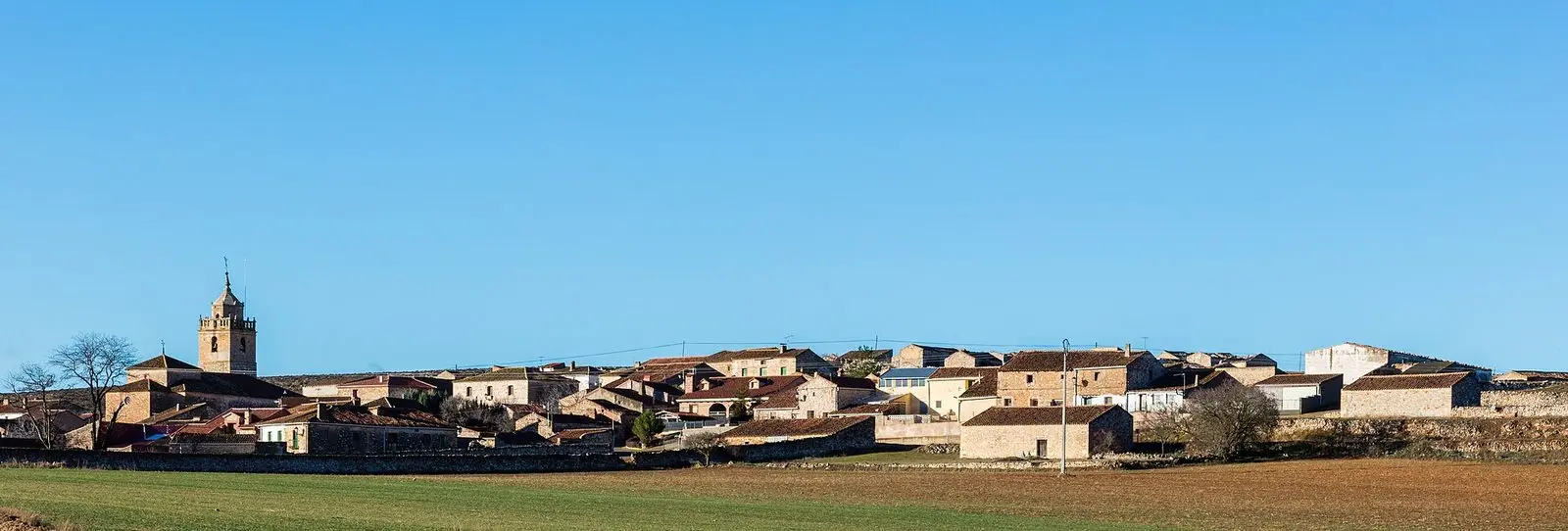 Panoramic view of Torrubia with its church and village houses below the hills.